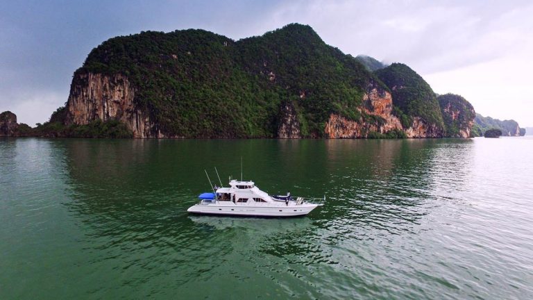 The Sea Urchin yacht anchored in front of a small island