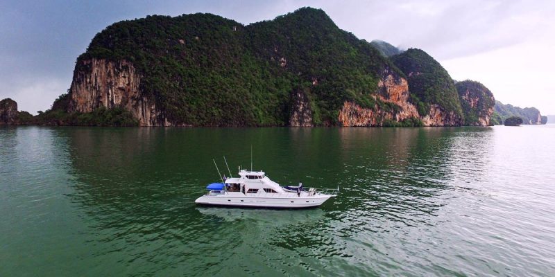 The Sea Urchin yacht anchored in front of a small island