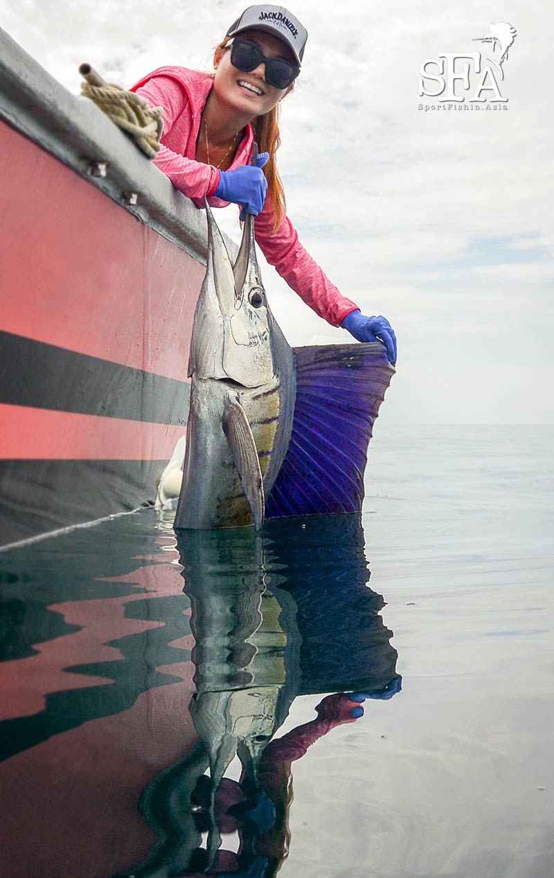 Our lady guest with her catch. Note how calm the sea can be in Rompin!
