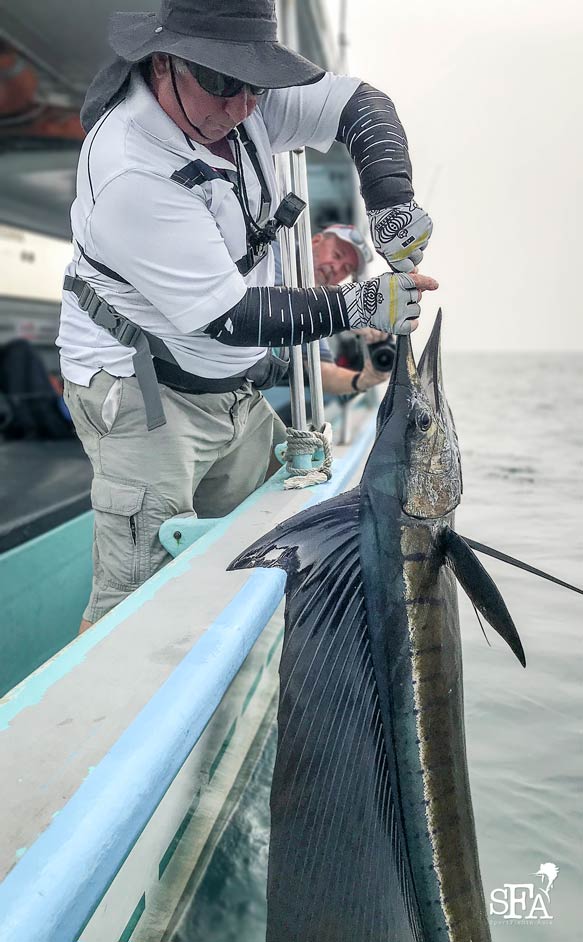 Graham posing for a quick pic with his sailfish by the boat side for a healthy release