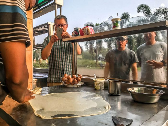 The guys fascinated with how the roti canai is made