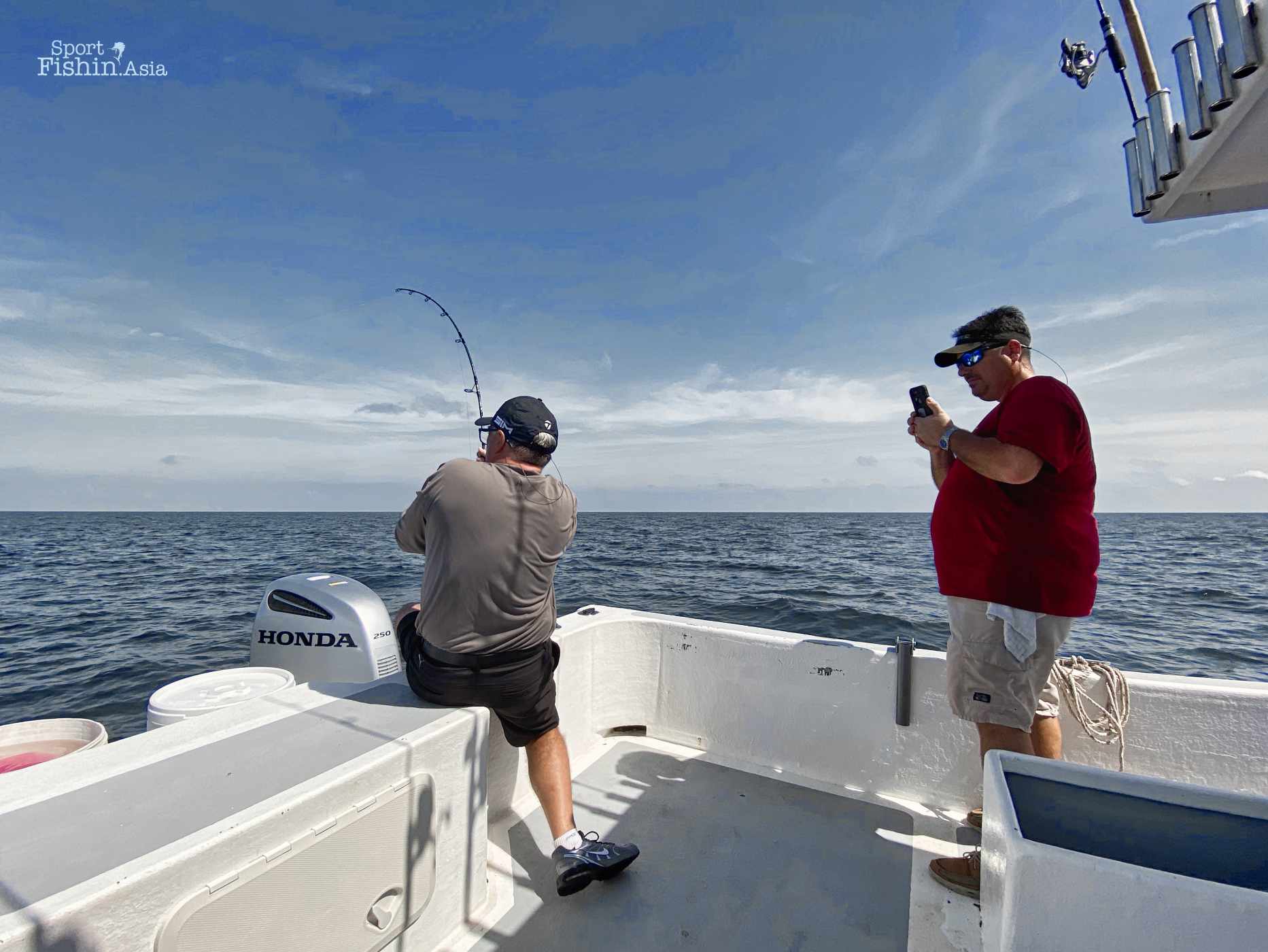 Ryan taking photos and videos of Brian with his first sailfish