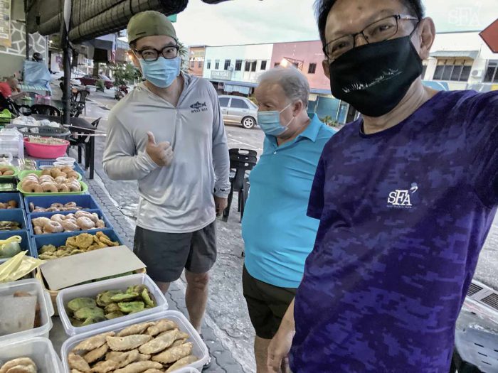 Masks on because of you know what. Shopping for snacks in a local market to much aboard the boat.